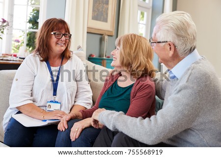 Female Support Worker Visits Senior Couple At Home
