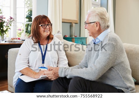 Female Support Worker Visits Senior Man At Home