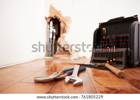 Tools and toolbox lying on flood damaged floor