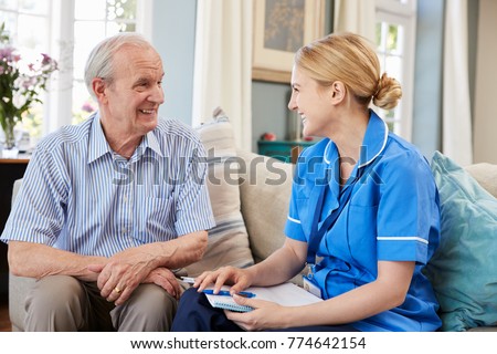 Female Community Nurse Visits Senior Man At Home