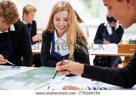 Group Of Teenage Students Studying Together In Art Class