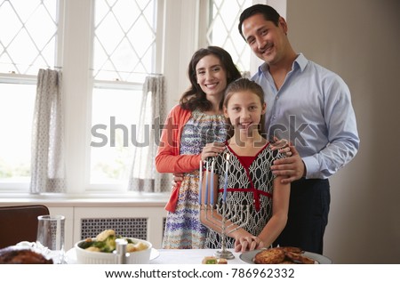 Jewish family smile to camera before Shabbat meal, close up