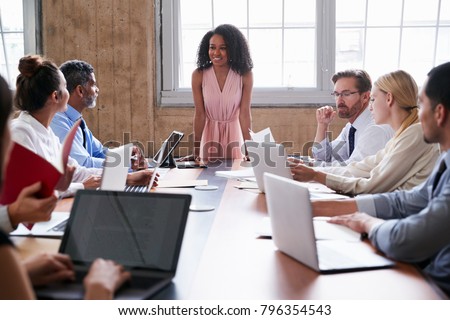 Black businesswoman addressing colleagues at a board meeting