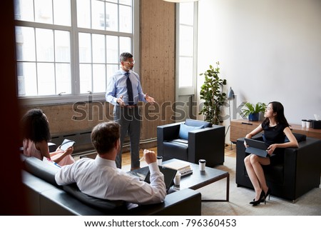 Male manager stands at an informal lounge meeting, close up