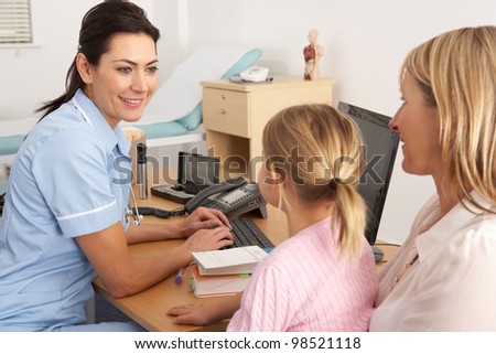 British nurse talking to young child and mother