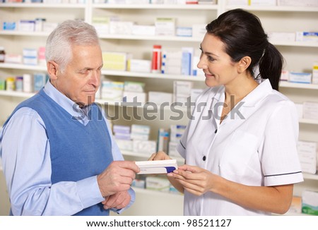 American pharmacist serving senior man in pharmacy American pharmacist serving senior man in pharmacy