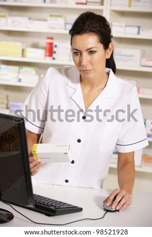 American pharmacist using computer in pharmacy