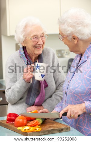 Senior women preparing meal together