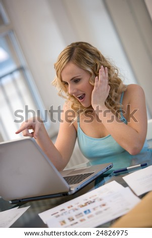 woman at laptop with surprised facial expression.Concept of emotion.