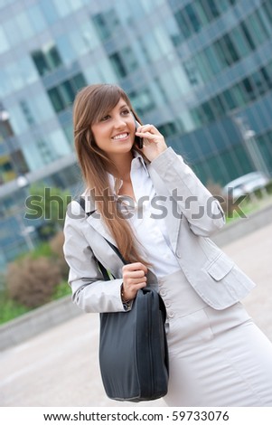 young caucasian businesswoman making a phone call outdoors.Concept of mobile communication