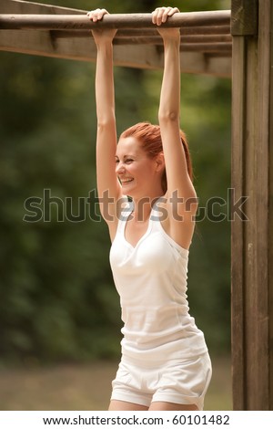 young woman doing physical exercise outdoors