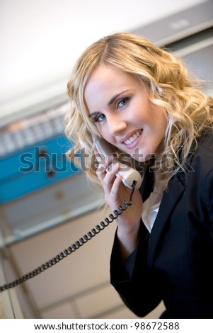 young caucasian businesswoman answering to the phone