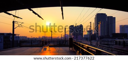 Sunrise at Electric Railway Station with Cityscape in Central Urban, Airport Rail Link in Bangkok, Thailand