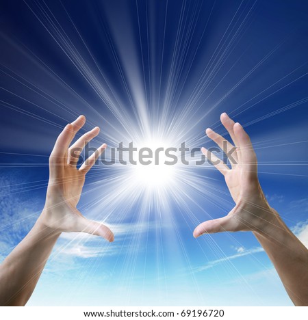 Sun in the hands on the blue sky. Freedom, harmony, spirituality concept
