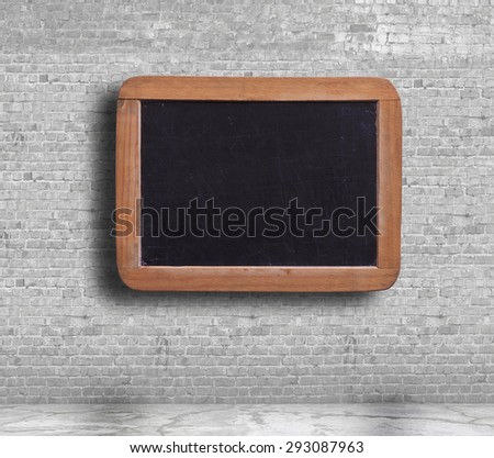 blank blackboard on the grey brick wall