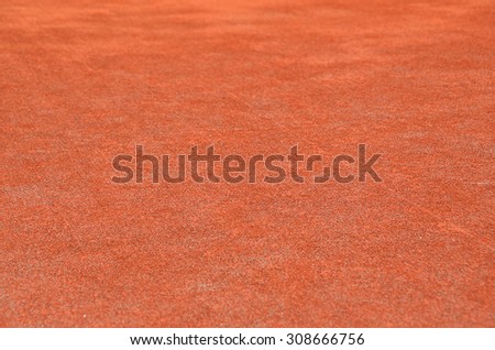 Red dry grungy clay tennis textured background