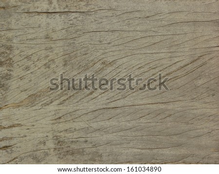 Old brown wood texture, covered with thin, shallow cracks of variousl lengths.