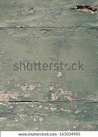 Old green wood texture, with various holes and cracks in its surface, and areas of heavily chipping green paint.