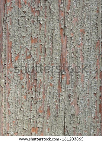 Old red wood texture covered witha chipping layer of light green paint.