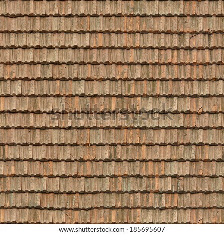 Old roof made of square, flat shingles in red and brown colors.