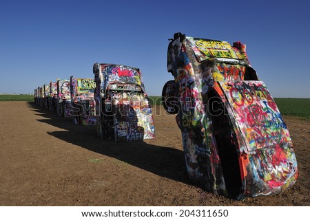 AMARILLO, TEXAS, USA,  - March. 27. 2012 : Cadillac near Amarillo, public art installation and sculpture in Amarillo, Texas, U.S. with ten Cadillac buried in a farm field near Rt. 66.