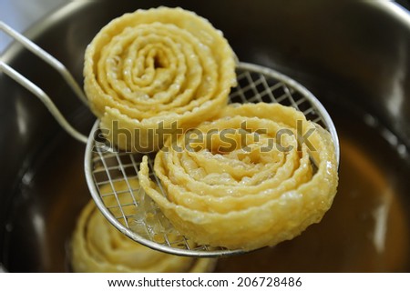 Honey Dipped Spiral Pastries, traditional sweet in Crete, Greece. It is crispy pastry spirals dipped in a honey syrup, traditionally made and served over the Christmas and New Year\'s holiday season