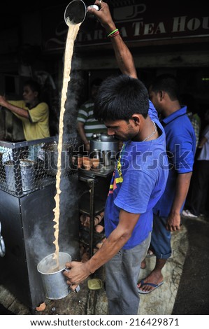 Kolkata, India, July. 10. 2012: Men preparing hot milk tea Indian style or chai at street vender, Kolkata, India