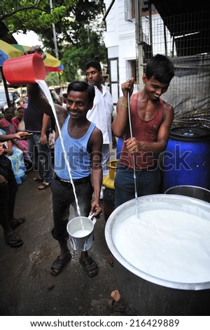 Kolkata, India,  July. 10. 2012: Men preparing hot milk tea Indian style or chai at street vender, Kolkata, India