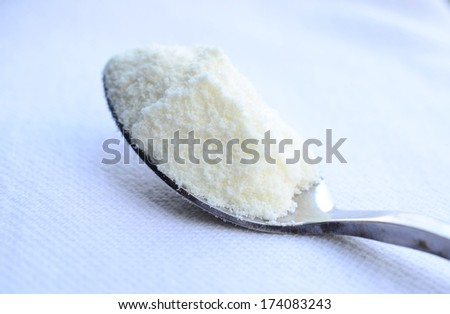 close up of powdered milk and spoon for baby