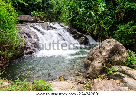 Tropical rainforest landscape with beautiful waterfall, rocks and jungle plants. Vang Vieng, Laos (kaeng nyui waterfall)