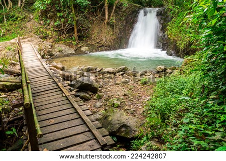 Tropical rainforest landscape with beautiful waterfall, rocks and jungle plants. Vang Vieng, Laos (kaeng nyui waterfall)
