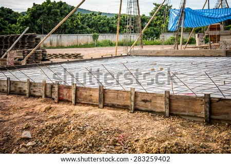 floor area covered in a sheet of plastic and a mesh of steel reinforcing rods