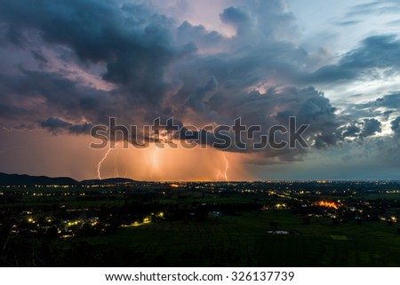 High angle view of Storm and lightning over villages