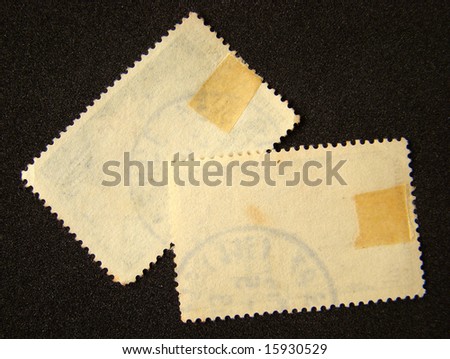 Blank postage stamps on black background.