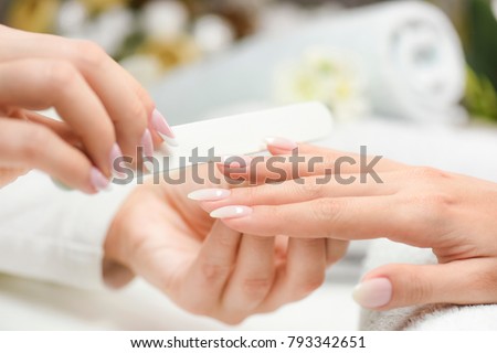 Nails manicure with file. Woman nails care. Beautiful nails after filling. Nails cosmetics.
