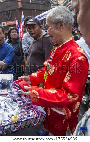 BKK - FEB 1, 2014: An old Chinese man, anti-government protester during a march at Bangkok\'s Chinatown.