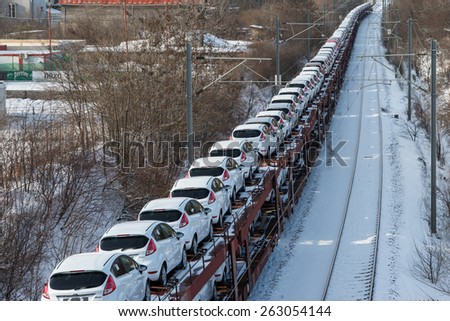 BUCHAREST, ROMANIA - February 9: A train full of new Ford Fiesta cars are exported by train in Bucharest, on February 9, 2015. The Ford Fiesta is a supermini car manufactured by the Ford Motor Company