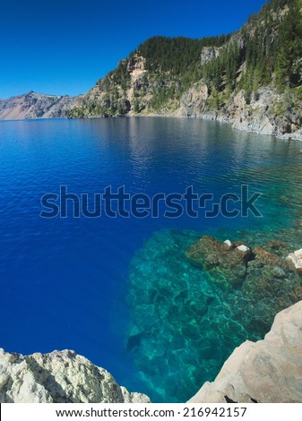 Crystal clear water of the Crater Lake. The lake is fed only by rainfall and snow-melt form the mountain ridge that encircles it, making the water extremely clean and clear.