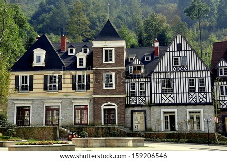 BAI LU TOWN, CHINA: Handsome French-inspired half-timbered and stucco houses line a village square *