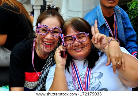 Bangkok Thailand, January 13, 2014:  Women wearing fun glasses in the red, white, & blue Thai flag colors at an Operation Shut Down Bangkok political protest aimed at toppling the government  *