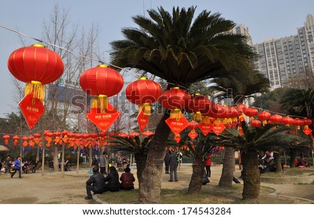 Pengzhou, China February 1, 2014:  Strings of bright red Chinese New Year lanterns decorate Pengzhou City Park
