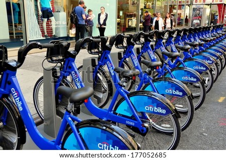 New York, NY - May 27, 2013:  Rows of the brand new Citibike rental bright blue bicycles emblazoned with the Citibank logo sit at a West 49th Street docking  station