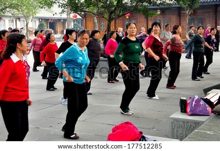 Langzhong Ancient City, China - October 22, 2013:  A group of Chinese women enjoy an afternoon dancing in unisom at one of the city\'s open plazas