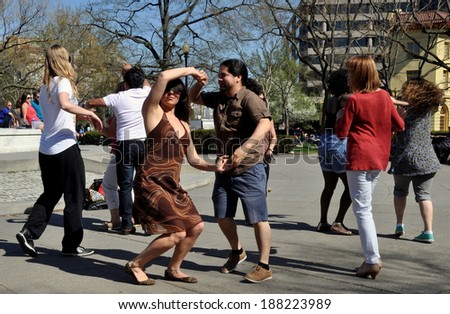 Washington, DC - April 12, 2014:  People doing Salsa dancing in the open plaza at Dupont Circle on a warm Spring afternoon