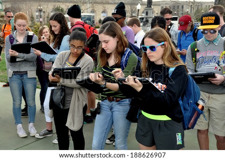Washington, DC - April 9, 2014:   A group of students on a school field trip taking notes while standing in the plaza of the Grant Memorial near the National Mall