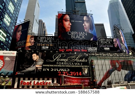 New York City - April 19, 2014: Giant advertising billboards cover building facades overlooking legendary Times Square