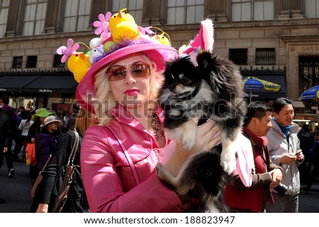 NYC - April 20, 2014:  An elegantly dressed woman holding her dog at the 2014 Easter Parade on Fifth Avenue