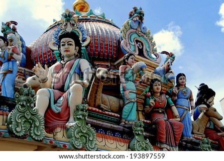 SINGAPORE - December 14, 2007:  Painted figures of Hindu gods and deities adorn the superb 1827 Sri Mariamman Temple in Chinatown