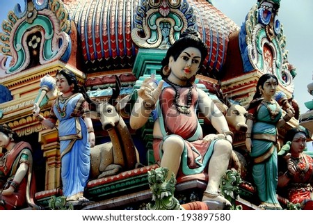 SINGAPORE - December 14, 2007:  Female goddesses and carved deers sit below a colourful roof dome at the 1827 Sri Mariamman Hindu Temple in Chinatown