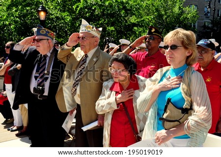 NYC - May 26, 2014:  Veterans and citizens stand at attention during the playing of the National Anthem at the Memorial Day holiday ceremonies in Riverside Park